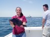 5-27 - Dana shows off her sea bass as Geoff looks on.